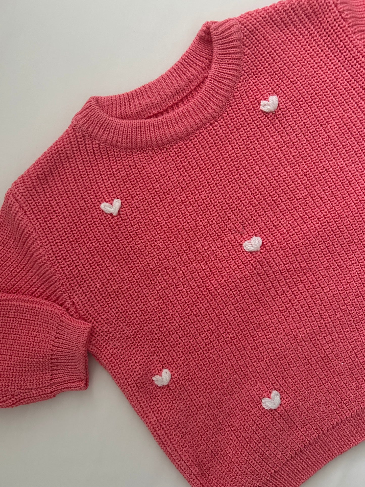 Bright pink embroidered baby’s jumper