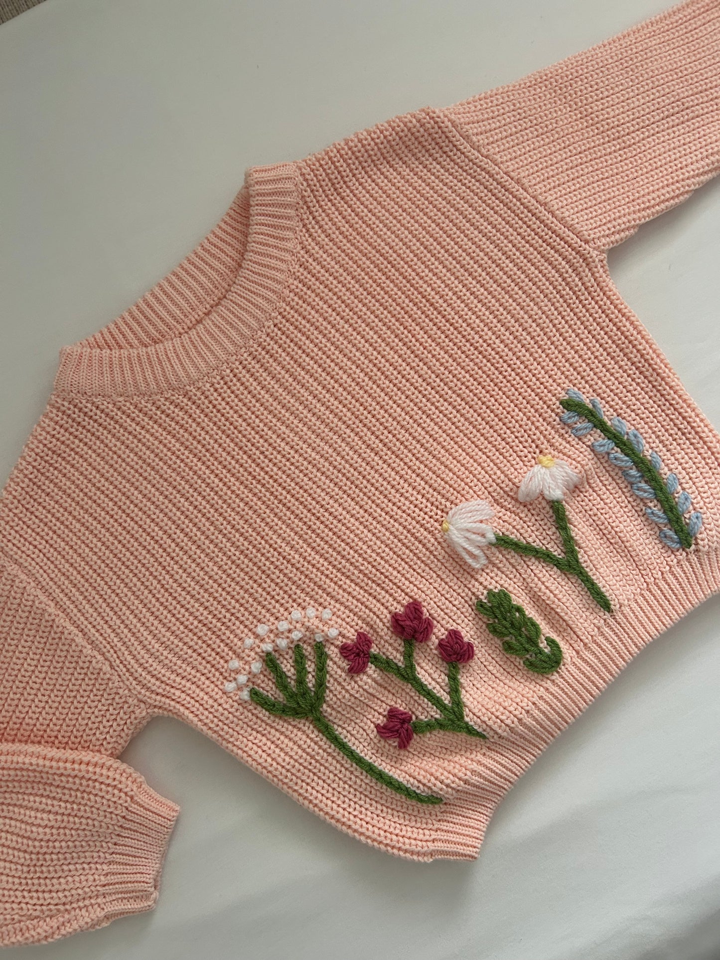 Peach embroidered baby’s jumper